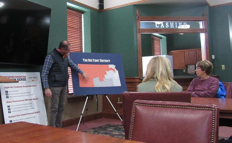 Kansas Big First District Congressman Tracey Mann points out a location within the district on a map during his visit to Leoti last week.