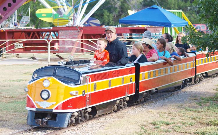 Robbie Berning conducts the fan-favorite train with some assistance from a young conductor-in-training.