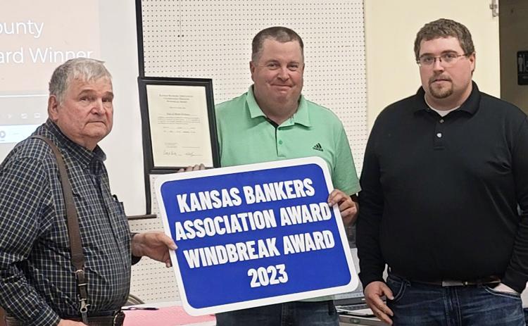 Tony Harkness and Brian Harkness of Harkness Repair, LLC, are presented with the Kansas Bankers Association Award 2023 Windbreak Award at the 76th Annual Meeting of the Wichita County Conservation District, held January 29, 2024, at the Community Building. Presenting the sign and plaque to the father/son duo is Tristan Perry of Security State Bank. Photo courtesy Darla Lewis