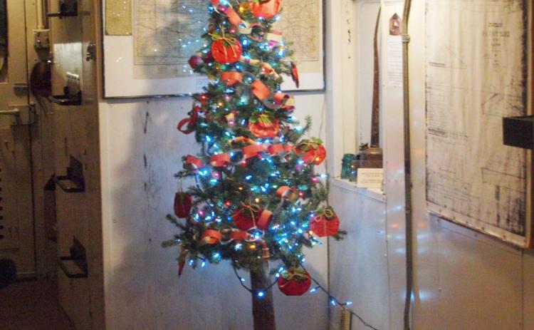 A festive Christmas tree inside the old caboose at the Museum.