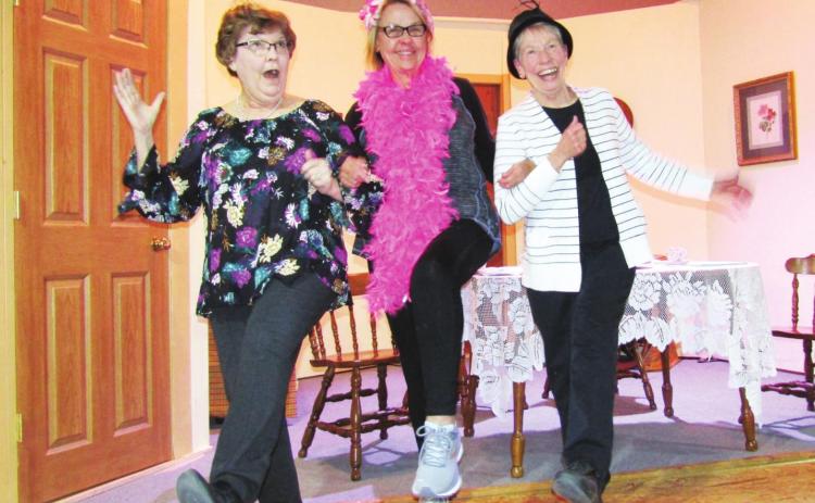 Left: Joy Brown, Kathy Bangerter, and Betsy Breitkreutz cut a rug during rehearsals for the Arts Alliance’s production of The Dandelion Ladies’ Decisive Tea.