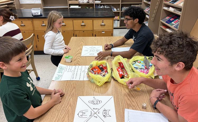 Second graders Conner Smith and Maggie Ames learn “Triple the Fun” from Santiago Garcia and Tyson Peters.