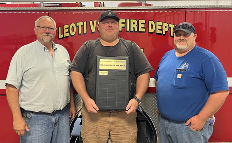 Leoti Volunteer Fire Department’s first Firefighter of the Year, Brian Downing, center, poses with Fire Chief Mike Nickelson and Asst. Fire Chief Steve Baum.